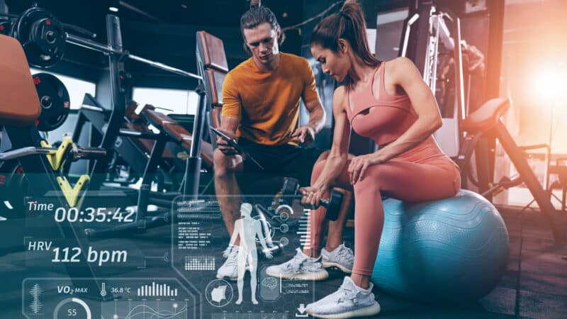 Modern technology in sport science concept. muscle strength training people in sport club overlay data chart body analysis diagram interface